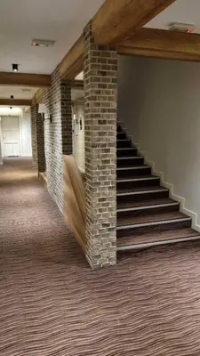 a staircase in a room with a brick wall at FEMI Kopaonik Apartment, Župa Aparthotel, Kopaonik Center in Kopaonik
