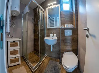 a bathroom with a toilet and a sink and a shower at Apartman Lucky 2 Kopaonik in Kopaonik