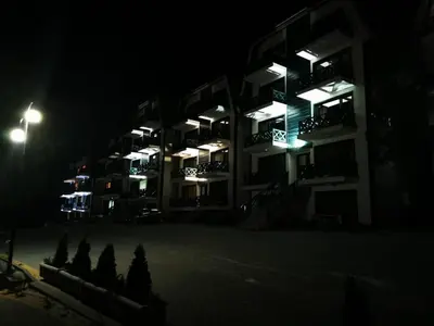 an apartment building at night with lights on at Apartman Lucky 2 Kopaonik in Kopaonik