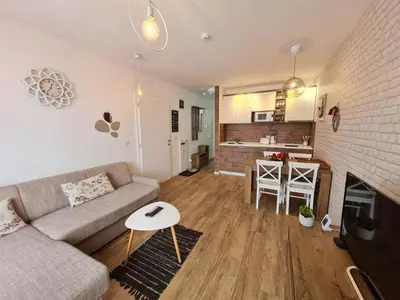 a living room with a couch and a table at Apartman Lucky 2 Kopaonik in Kopaonik
