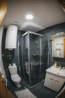 a bathroom with a shower and a toilet and a sink at MIR i LIRA apartmani Kopaonik in Kopaonik