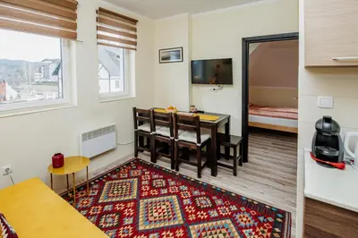 a small room with a table and a bed at Apartman No.32a-JollyKop in Kopaonik