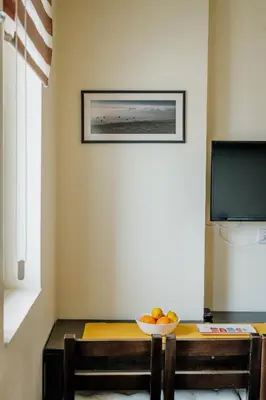 a dining room table with a bowl of fruit on it at Apartman No.32a-JollyKop in Kopaonik