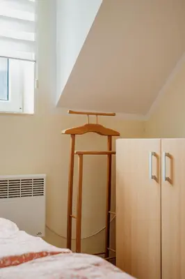 a bedroom with a bed and a table and a cabinet at Apartman No.32a-JollyKop in Kopaonik