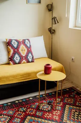 a bed with a table with a red candle on it at Apartman No.32a-JollyKop in Kopaonik