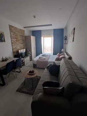 a living room with a couch and a bed at Apartman MOUNTAIN VIEW Milmari Resort in Kopaonik