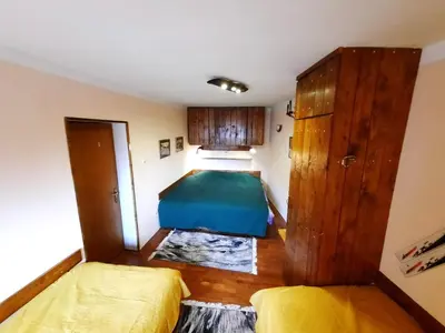a small bedroom with two beds and a cabinet at Apartman Pod bregom - Gondola 180m in Brzeće