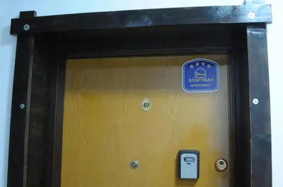 a wooden door with a sign on top of it at Apartman Pod bregom - Gondola 180m in Brzeće