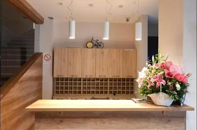 a bench in a room with flowers on it at Luna Apartman, Župa Kopaonik in Kopaonik