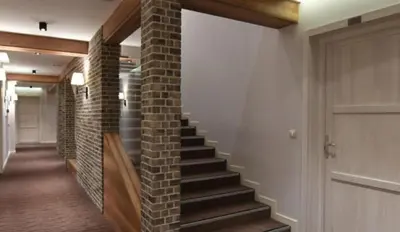 a hallway with a brick wall and a staircase at Lola Apartment - Župa, Kopaonik in Kopaonik