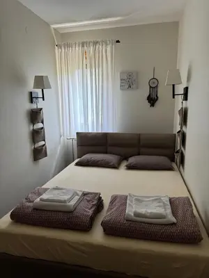 a bed with two pillows on it in a bedroom at Lola Apartment - Župa, Kopaonik in Kopaonik