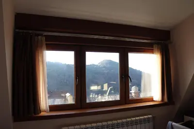 a window with a view of a mountain at Apartman Snesko Zoned in Kopaonik