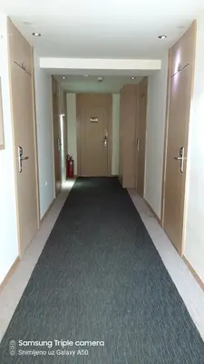 an empty hallway with doors and a carpet at S Konaci in Kopaonik