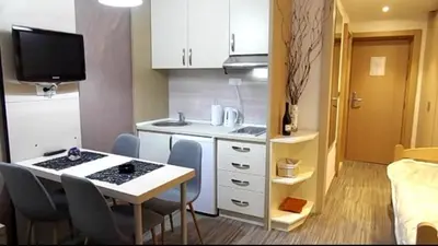 a small kitchen with a table and chairs in a room at S Konaci in Kopaonik
