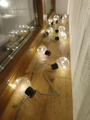 a row of lights sitting on a wooden floor at Milmari ApartmanVid N57 in Kopaonik