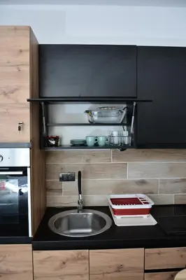 a kitchen counter with a sink and a stove at Milmari ApartmanVid N57 in Kopaonik