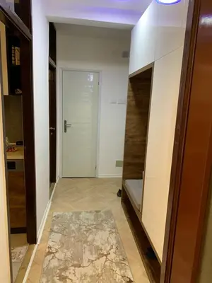 a hallway with a room with a door and a rug at Aleksinac in Aleksinac