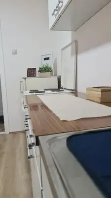 a white kitchen with a counter top with a counter top at Apartman Pavlovic in Leskovac