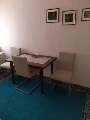 a dining room with a table and two chairs at Anka in Jagodina