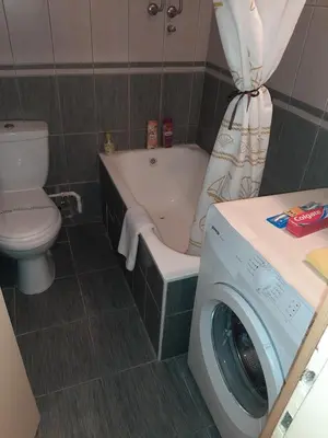 a bathroom with a toilet and a washing machine at Anka in Jagodina
