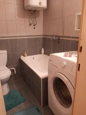 a bathroom with a washing machine and a toilet at Anka in Jagodina