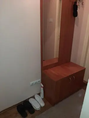 a bathroom with a wooden dresser and a mirror at Anka in Jagodina