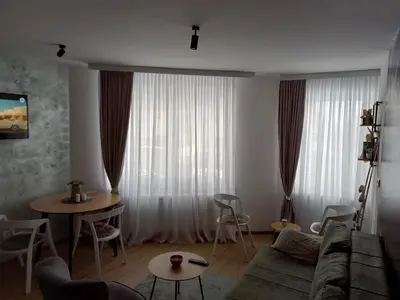 a living room with a couch and a table at Pogled iznad oblaka in Kopaonik