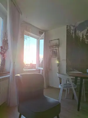 a room with a chair and a table and a window at Pogled iznad oblaka in Kopaonik