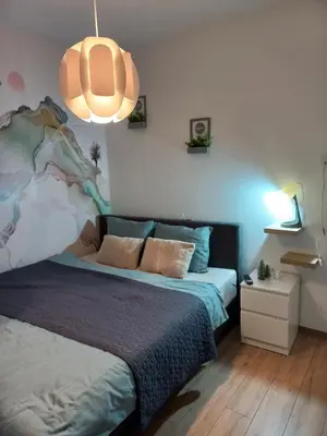 a bedroom with a bed and a pendant light at Pogled iznad oblaka in Kopaonik