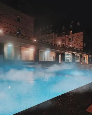 a swimming pool at night with smoke around it at Kraljevi Cardaci Olja in Kopaonik