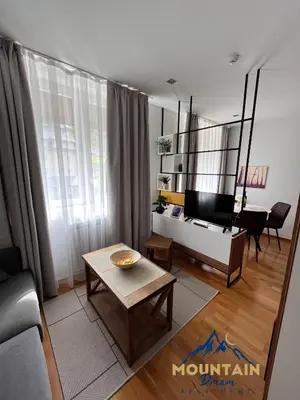 a living room with a couch and a table at Fully Equiped, Quiet, for 5 persons, Next To Panoramic Gondola in Brzeće