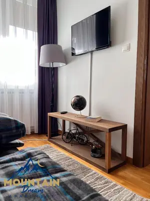 a living room with a table and a flat screen tv at Fully Equiped, Quiet, for 5 persons, Next To Panoramic Gondola in Brzeće