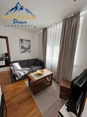 a living room with a couch and a table at Fully Equiped, Quiet, for 5 persons, Next To Panoramic Gondola in Brzeće