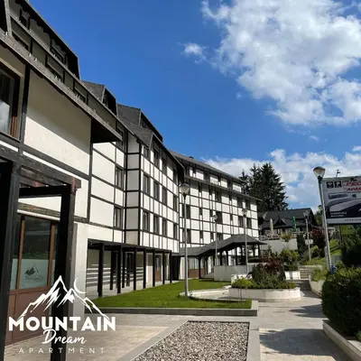 a building with a mountain dream sign in front of it at Fully Equiped, Quiet, for 5 persons, Next To Panoramic Gondola in Brzeće