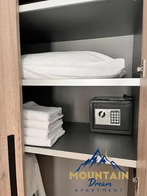 a shelf with a bed and a clock and towels at Fully Equiped, Quiet, for 5 persons, Next To Panoramic Gondola in Brzeće