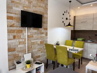 a kitchen and dining room with a brick wall at Milmari P74, Quest apartmani, Kopaonik in Kopaonik