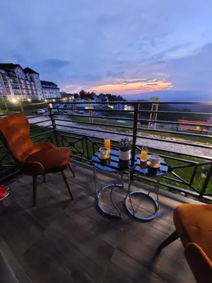 a balcony with a table and a view of a train at N-delux apartman in Kopaonik