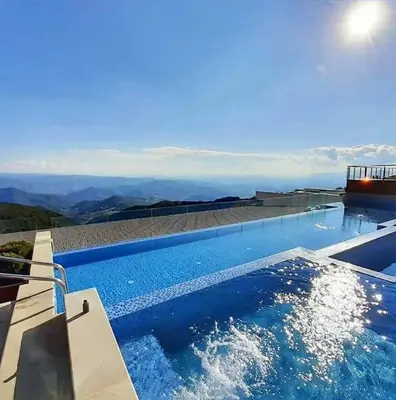 a swimming pool with a view of the mountains at N-delux apartman in Kopaonik