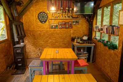 a room with a table and chairs in a tiny house at Zimska idila in Crni Vrh