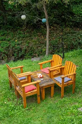 a wooden table and two chairs and a wooden table and chairs at Zimska idila in Crni Vrh