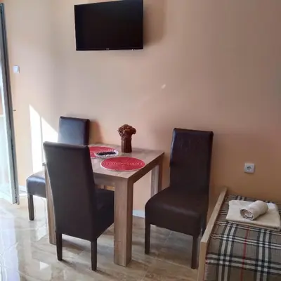 a dining room with a table and two chairs at Vila Suzana in Vrnjačka Banja