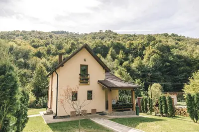a house in the middle of a field with trees at Zeleni svet 2 in Crni Vrh