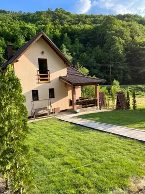 a house with a view of a yard at Zeleni svet 2 in Crni Vrh