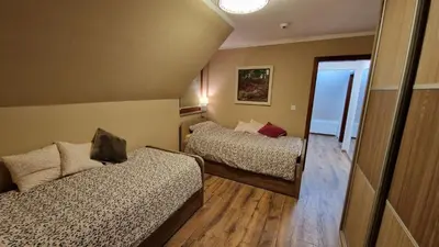 a small room with two beds and a mirror at Ski House in Kopaonik