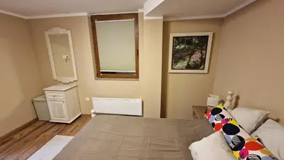 a small bedroom with a bed and a window and a window at Ski House in Kopaonik
