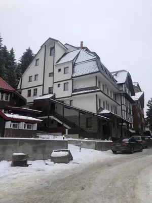 a large white building with snow on top of it at Ski House in Kopaonik