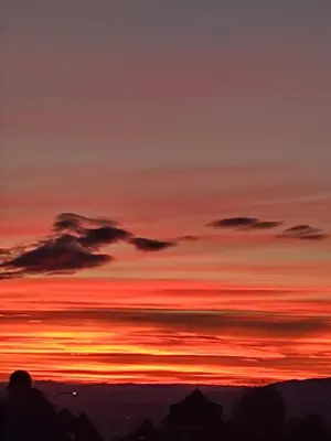 a sunset in the mountains with a person looking at it at Milmari N 79 in Kopaonik
