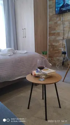a table with a glass of wine and a book at Milmari N 79 in Kopaonik
