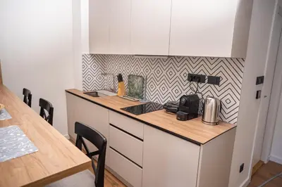 a kitchen with a counter and a table with chairs at Mountain Chalet Kopaonik in Kopaonik