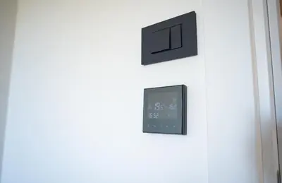 a clock hanging on a wall next to a door at Mountain Chalet Kopaonik in Kopaonik